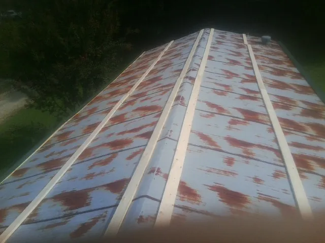 Rusted metal roof panels with new wood purlins before replacement — Storm Damage Roof Repair in Ridley Park by Roofing Brothers