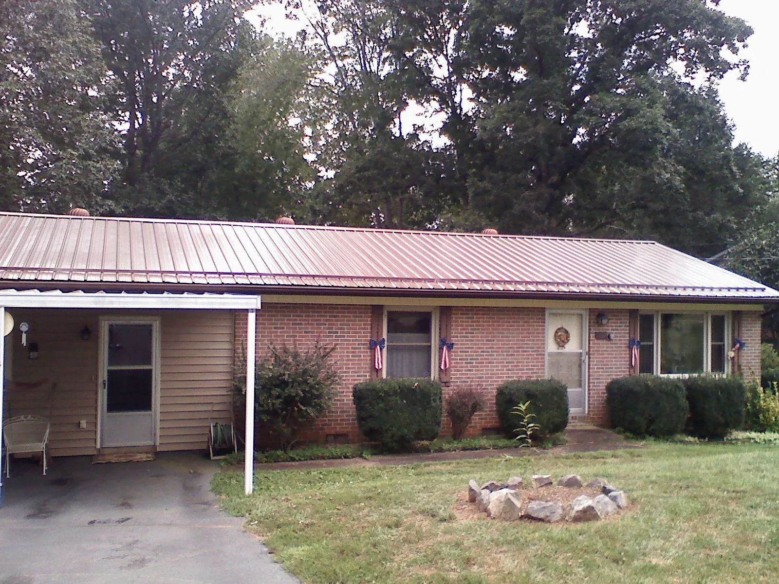 Bronze metal roof and carport on a brick ranch home — Roof Repair work by our crew in Ridley Park